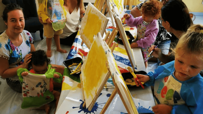 Enfants participant à un atelier peinture sur chevalet. L'Arbre à Bulles